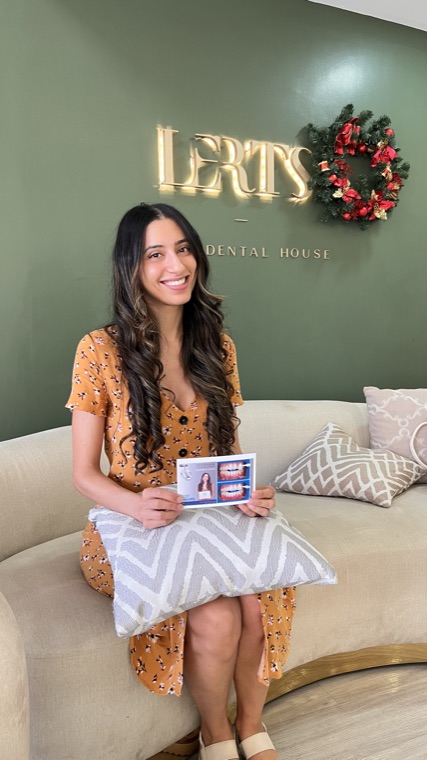 Patient holding her before-and-after smile card at the Dental Excellence studio, Chiang Mai