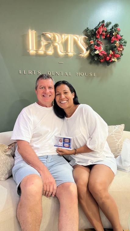 Couple holding their before-and-after smile card at Dental Excellence by LERTs, Chiang Mai