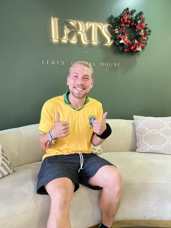 Smiling patient giving two thumbs up at Dental Excellence by LERTs, Chiang Mai